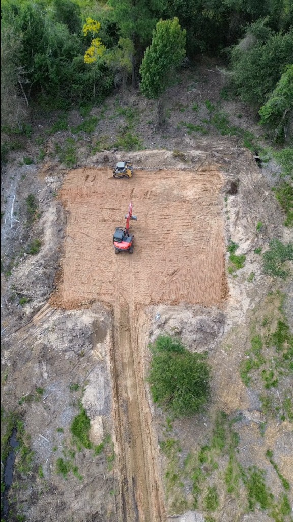 Excavator moving dirt on a prepared job site