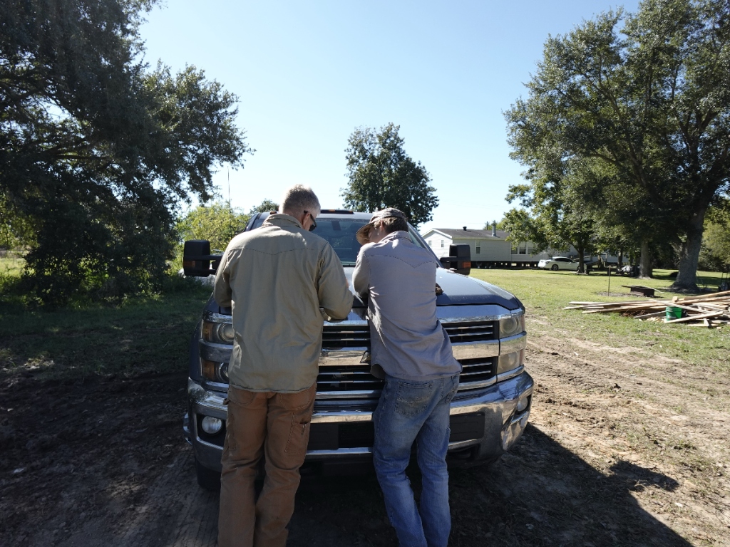 Two Upward Development crew members talking on a job site
