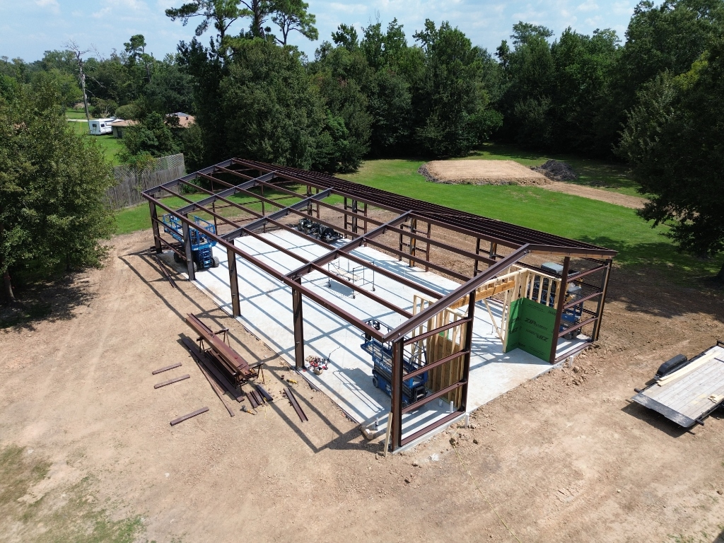 Completed steel building with roll-up doors on a finished site